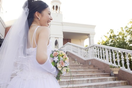 Rear View of the bride standing on stairsの写真素材