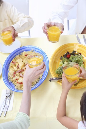 Family around the dining tableの写真素材