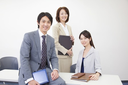 Businessman and OL smiling in a conference roomの写真素材