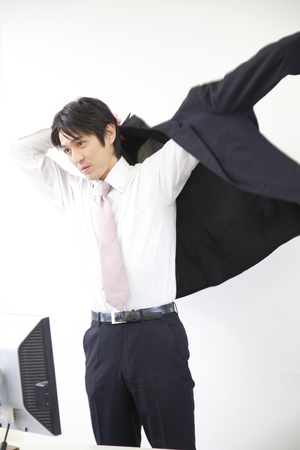 Businessman to put on a jacketの写真素材