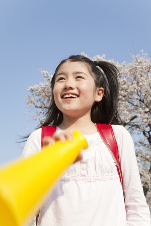 Elementary school students with a megaphone womenの写真素材