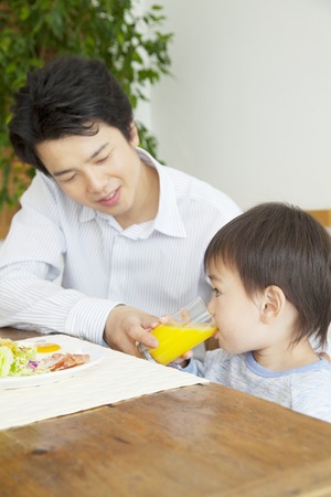 Otokonoko drinking orange juiceの写真素材