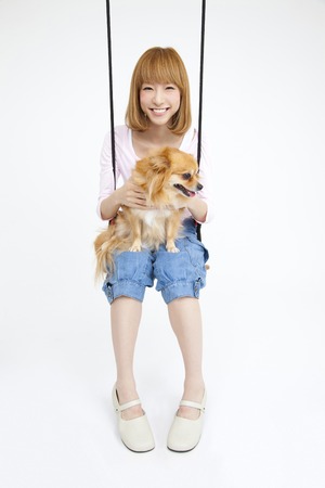 Female Chihuahua on the swing ride with a smileの写真素材