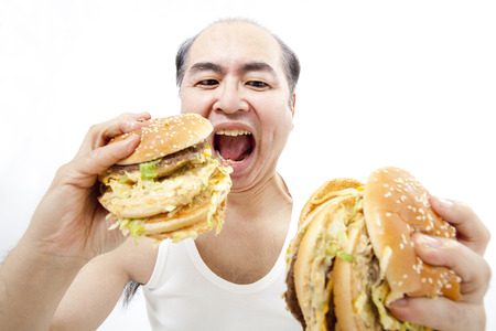 Middle-aged eat a hamburger manの写真素材