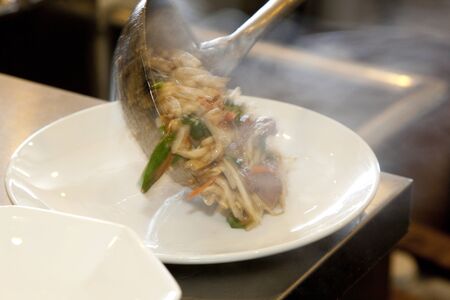 Hand to place  in a serving dish fried Rebaniraの写真素材