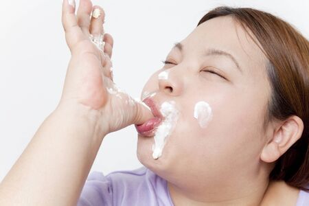 Metabo woman licking the creamの写真素材