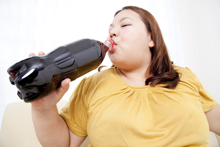 Overweight syndrome women who drink colaの写真素材