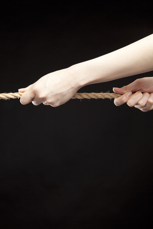 Hands grab the ropeの写真素材