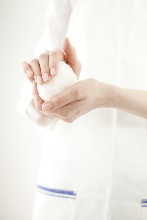 Hand hold the onigiriの写真素材