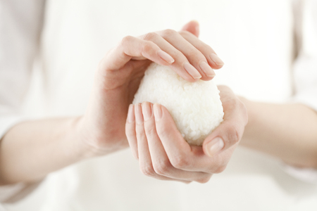 Hand hold the onigiriの写真素材