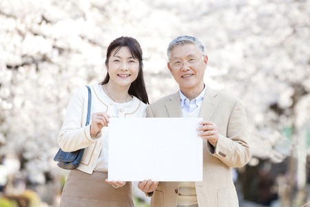 Senior couple with message boardの写真素材