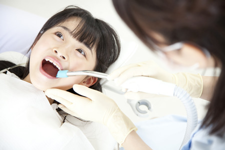Girls subjected to dental treatmentの写真素材