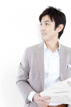 Businessman with newspaperの写真素材