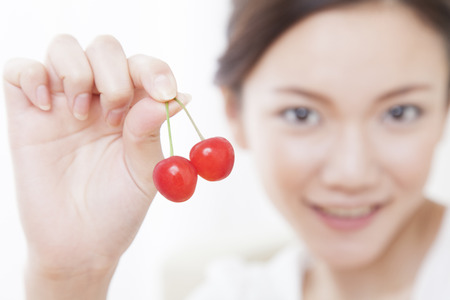 Woman with cherriesの写真素材