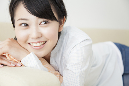 Girls lounging on the sofaの写真素材
