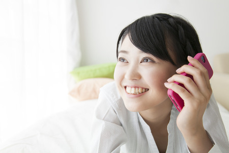 Girl to call on the bedの写真素材