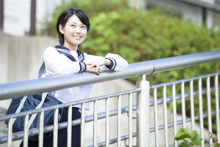 Junior high school girls that views from the handrailの写真素材