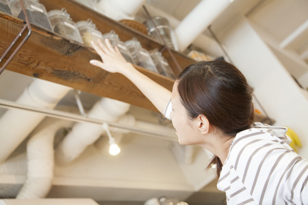 To reach a cafe clerk in cupboardの写真素材