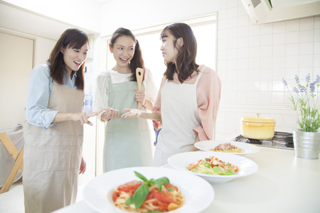 Women to the rock-paper-scissors in the kitchenの写真素材