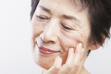 Senior woman to worry about the wrinklesの写真素材