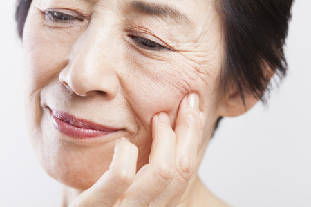 Senior woman to worry about the wrinklesの写真素材