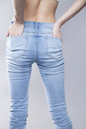 Back shot of a woman wearing a denim pants