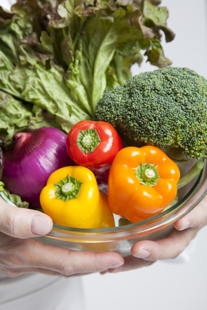 Cook smiling with a vegetableの写真素材