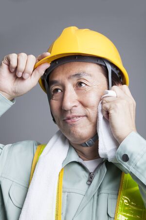 Workers wipe the sweat with a towel