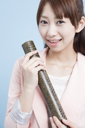 Female university students holding diplomasの写真素材