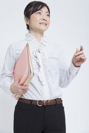 Businesswoman holding documentsの写真素材