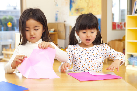 Folding origami nursery girlsの写真素材