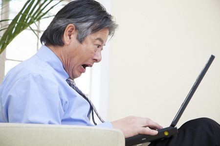 Businessman surprised to see a laptopの写真素材