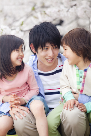 Father who holds the two childrenの写真素材