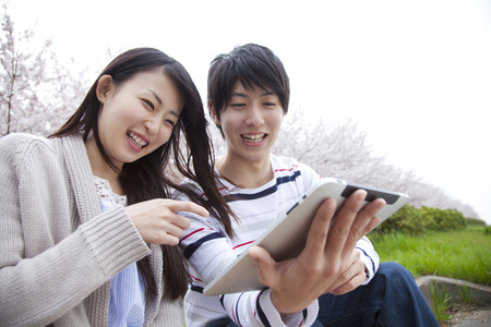 Couple of smile that touch the tablet PCの写真素材