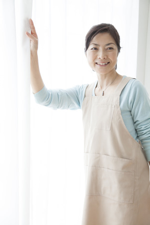 Housewife to open the curtainの写真素材