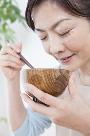 Housewife drink miso soupの写真素材