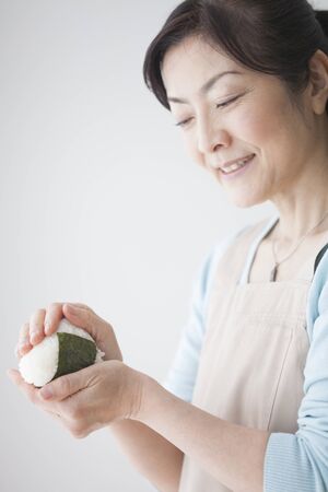 Housewives hold the onigiriの写真素材