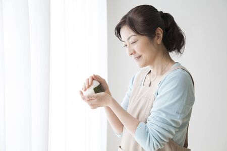 Housewives hold the onigiriの写真素材