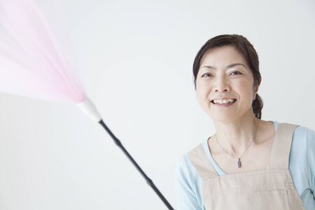 Housewife smile with a dusterの写真素材