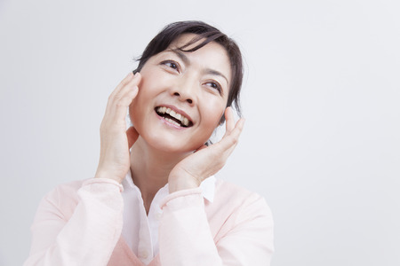 Middle women rejoice place your hand in faceの写真素材