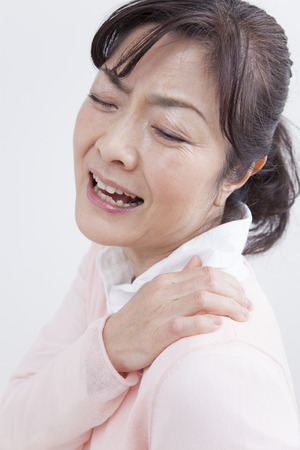 Middle women suffer from stiff neckの写真素材