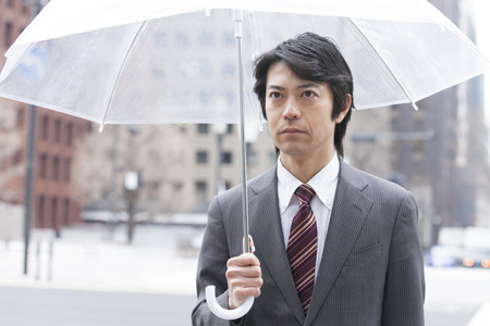 Businessman walking umbrellaの写真素材
