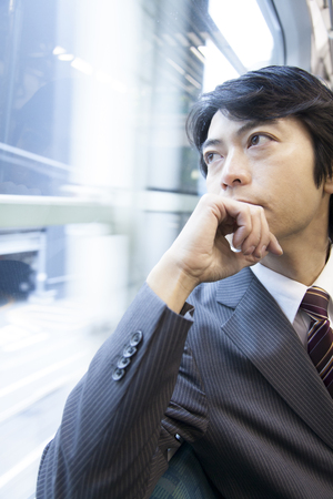 Businessman overlooking the car windowの写真素材