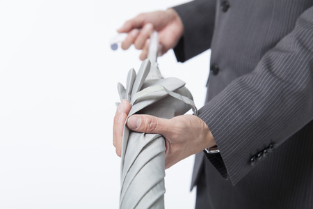Businessman to fold an umbrellaの写真素材