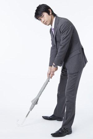 Businessman to a golf umbrellaの写真素材