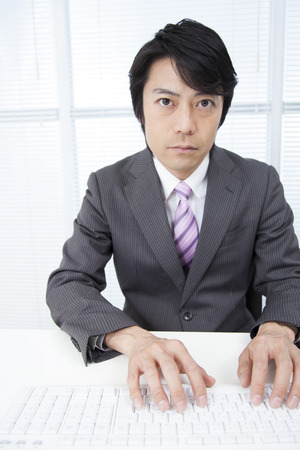 Businessman tapping a keyboardの写真素材