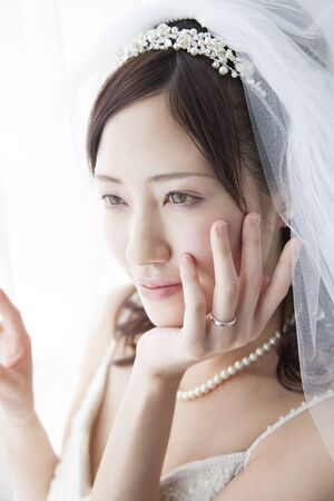Bride shed a hand to the faceの写真素材