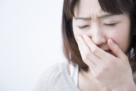 Middle women to suppress the mouthの写真素材