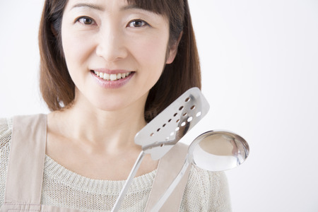 Housewife smile with a cookwareの写真素材