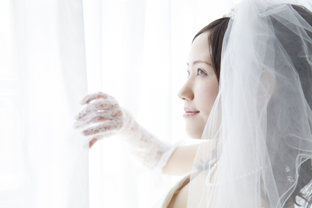Bride opening the curtainの写真素材